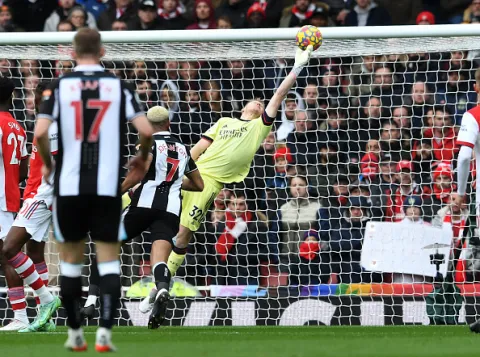 Ramsdale catches the ball in a game against Newcastle.